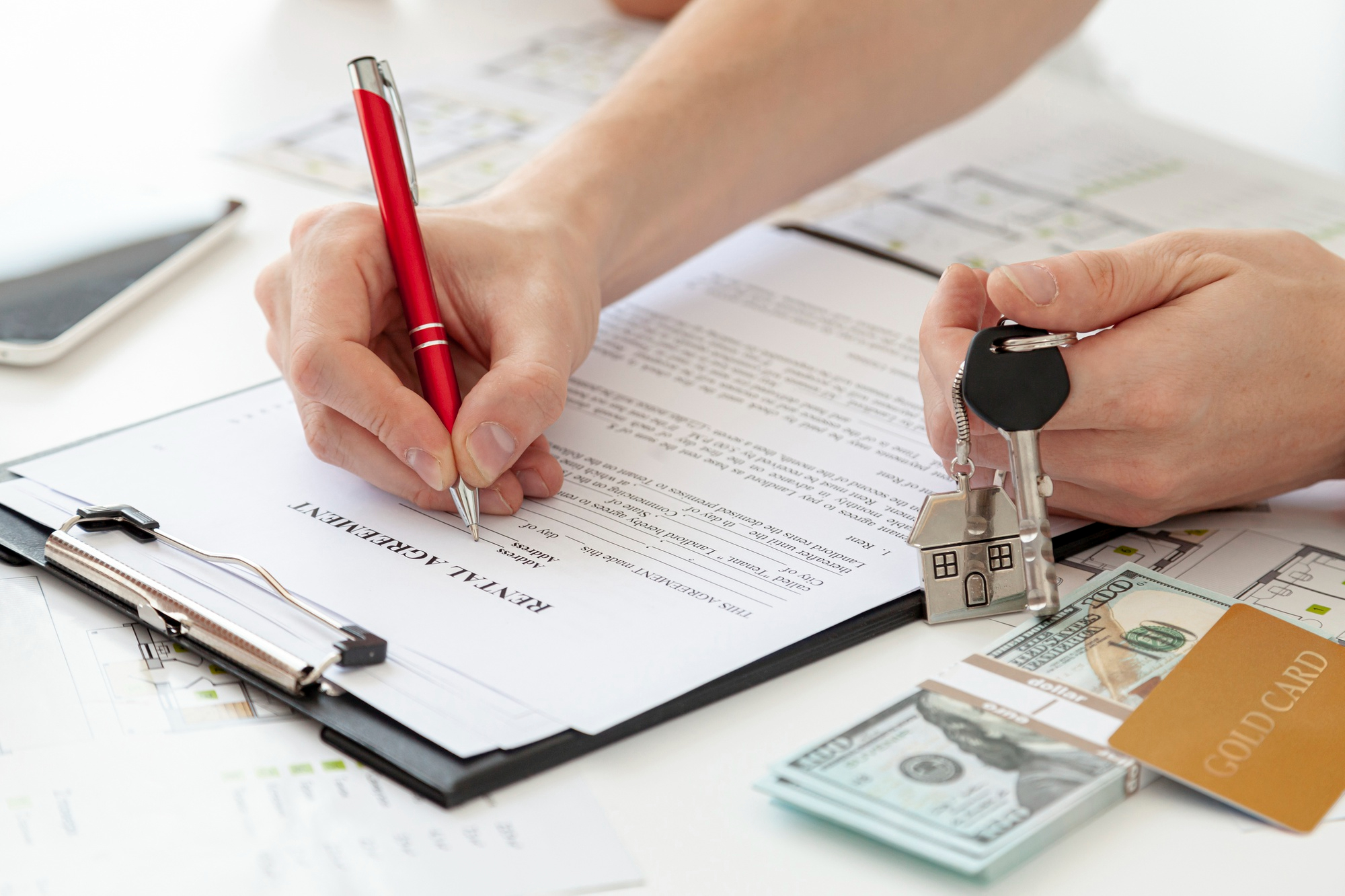 Modern legal documents on a wooden desk with coffee cup and glasses showing rental agreement terms